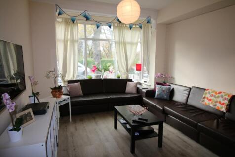 Spacious and inviting living room featuring lar...