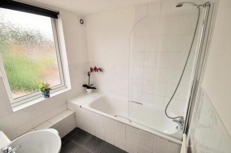 A modern bathroom featuring a spacious bathtub ...
