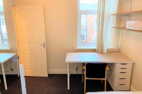This spacious double bedroom features ample nat...