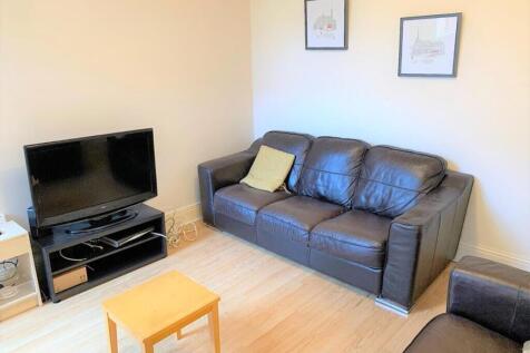 A cozy living room featuring a comfortable leat...