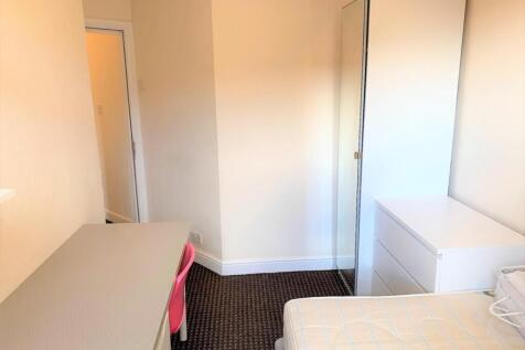 A bright and inviting double bedroom featuring ...