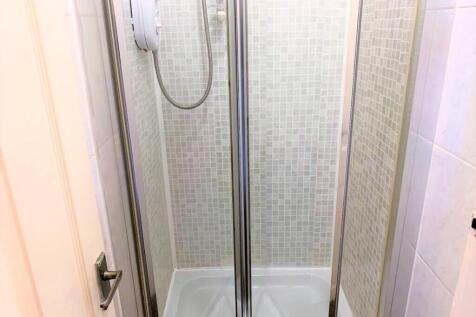 A modern bathroom featuring a sleek shower encl...