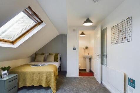 A charming and well-lit double bedroom with sty...