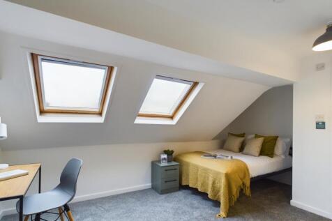 A bright and inviting double bedroom with moder...