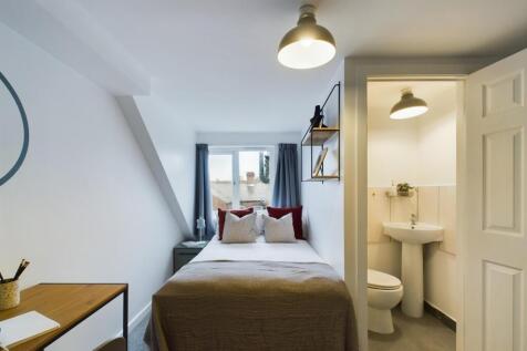 A bright and inviting double bedroom featuring ...