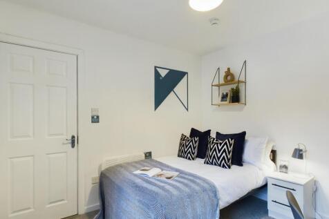 A stylish and inviting double bedroom with mode...