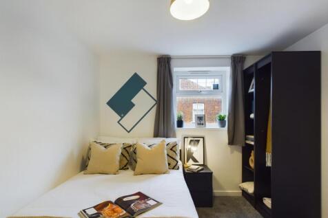 A bright and inviting double bedroom featuring ...