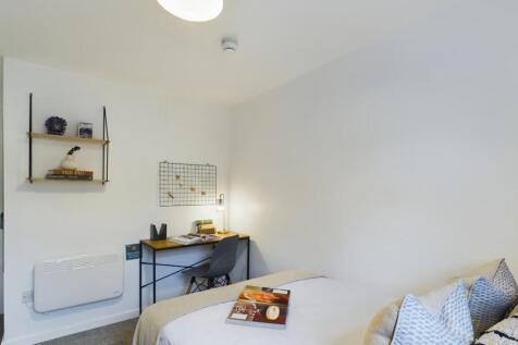 A bright and tidy double bedroom featuring a wo...