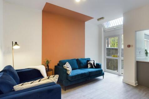A spacious and stylish modern living room fille...
