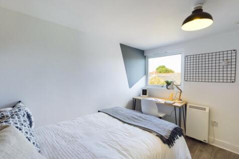 A bright and inviting double bedroom featuring ...