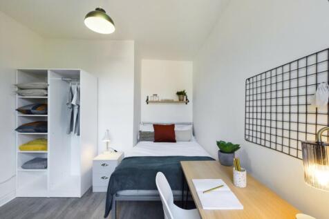 A bright and inviting double bedroom featuring ...