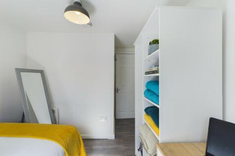 A bright and tidy double bedroom featuring styl...