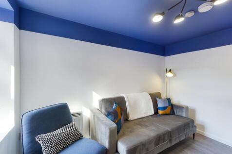 A stylish and inviting living room with modern ...