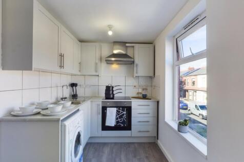 A bright and modern kitchen featuring ample cou...