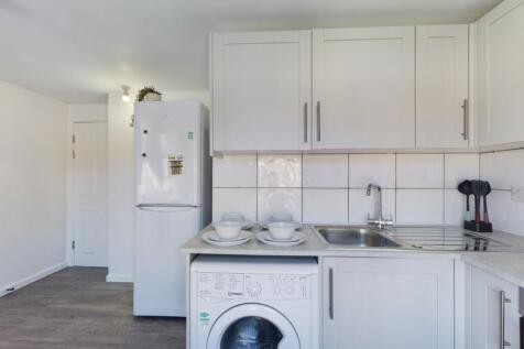 A bright and clean kitchenette equipped with mo...