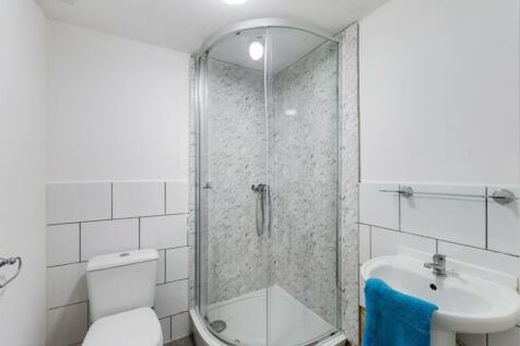 A modern bathroom featuring a stylish shower an...