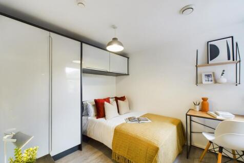 A stylish and well-lit double bedroom featuring...