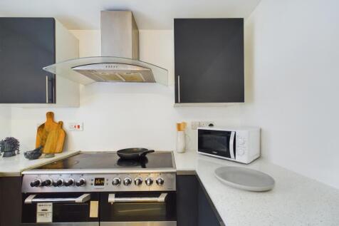 A modern and clean kitchenette featuring stylis...