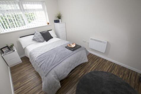 A bright and inviting double bedroom with moder...