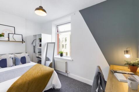 A bright and inviting double bedroom featuring ...