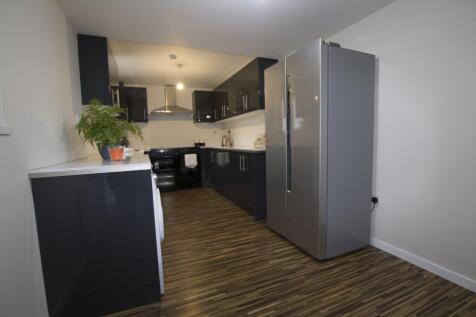 A modern and spacious kitchenette featuring sle...