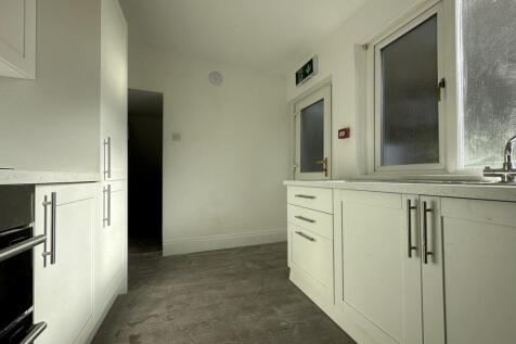 A modern kitchenette with ample storage and nat...