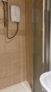 A modern bathroom featuring a sleek shower and ...
