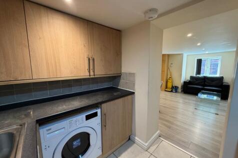 A stylish kitchen featuring modern cabinetry an...