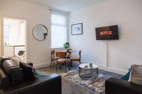 A stylish and inviting living room featuring co...