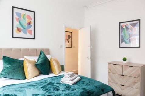 This inviting double bedroom features a stylish...