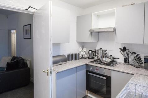 This modern kitchen features sleek cabinetry an...