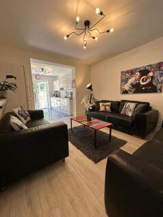 A stylish and spacious living room featuring mo...