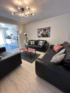 A stylish living room featuring comfortable bla...