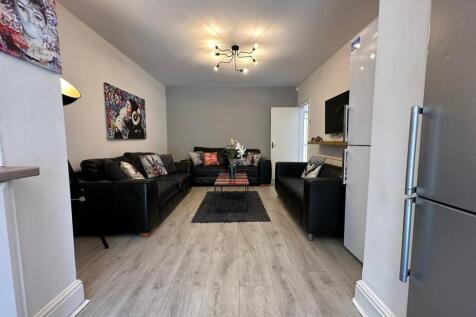 Spacious and modern living room featuring comfo...