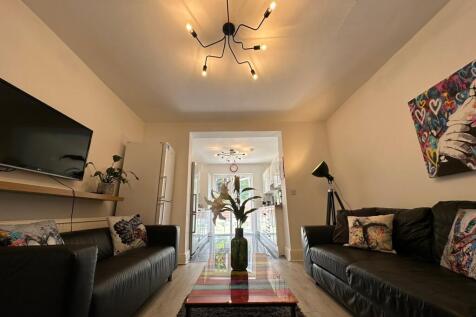 A stylish and spacious living room featuring mo...