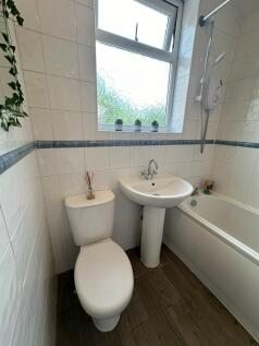 Bright and well-maintained bathroom featuring a...