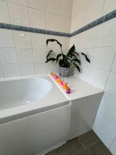 Bright and inviting bathroom featuring a clean,...