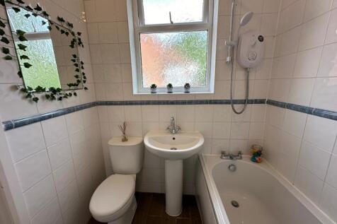 This well-maintained bathroom features a modern...