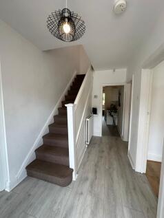 Welcoming hallway featuring stylish lighting an...