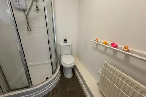 This modern bathroom features a sleek shower en...