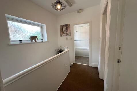 Welcoming hallway featuring natural light from ...