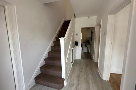 Welcoming hallway featuring modern flooring and...