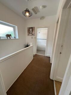 Welcoming hallway with natural light and stylis...