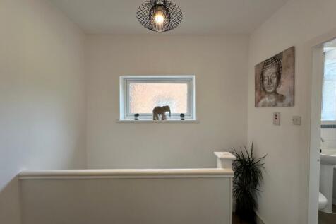 Bright and inviting hallway featuring modern de...