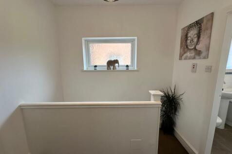 A bright and inviting hallway with stylish deco...