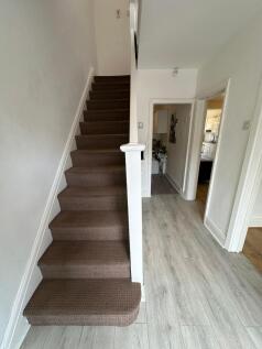 A well-maintained staircase leading to upper le...