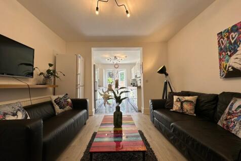 A stylish and inviting living room featuring tw...
