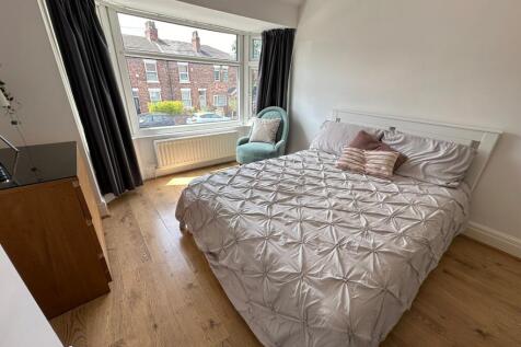 Bright and spacious double bedroom featuring a ...