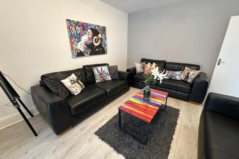 A stylish living room featuring comfortable bla...