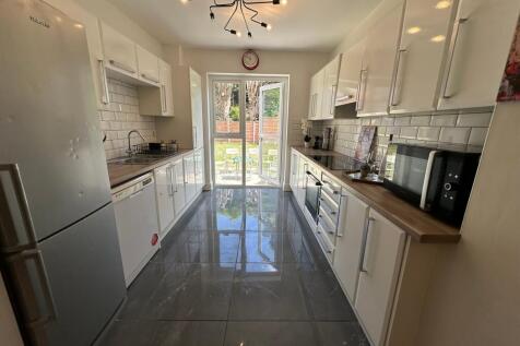 This modern kitchen features sleek cabinetry an...